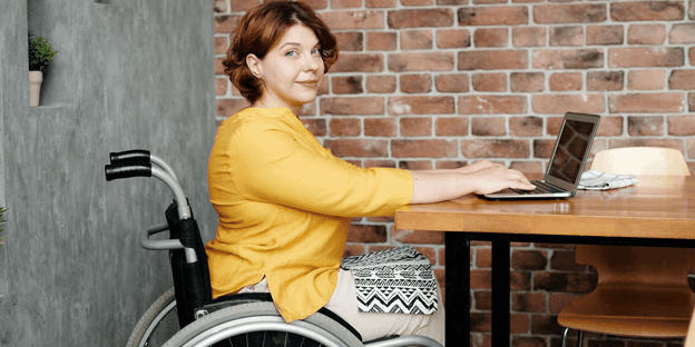 Woman in a wheelchair working on a laptop